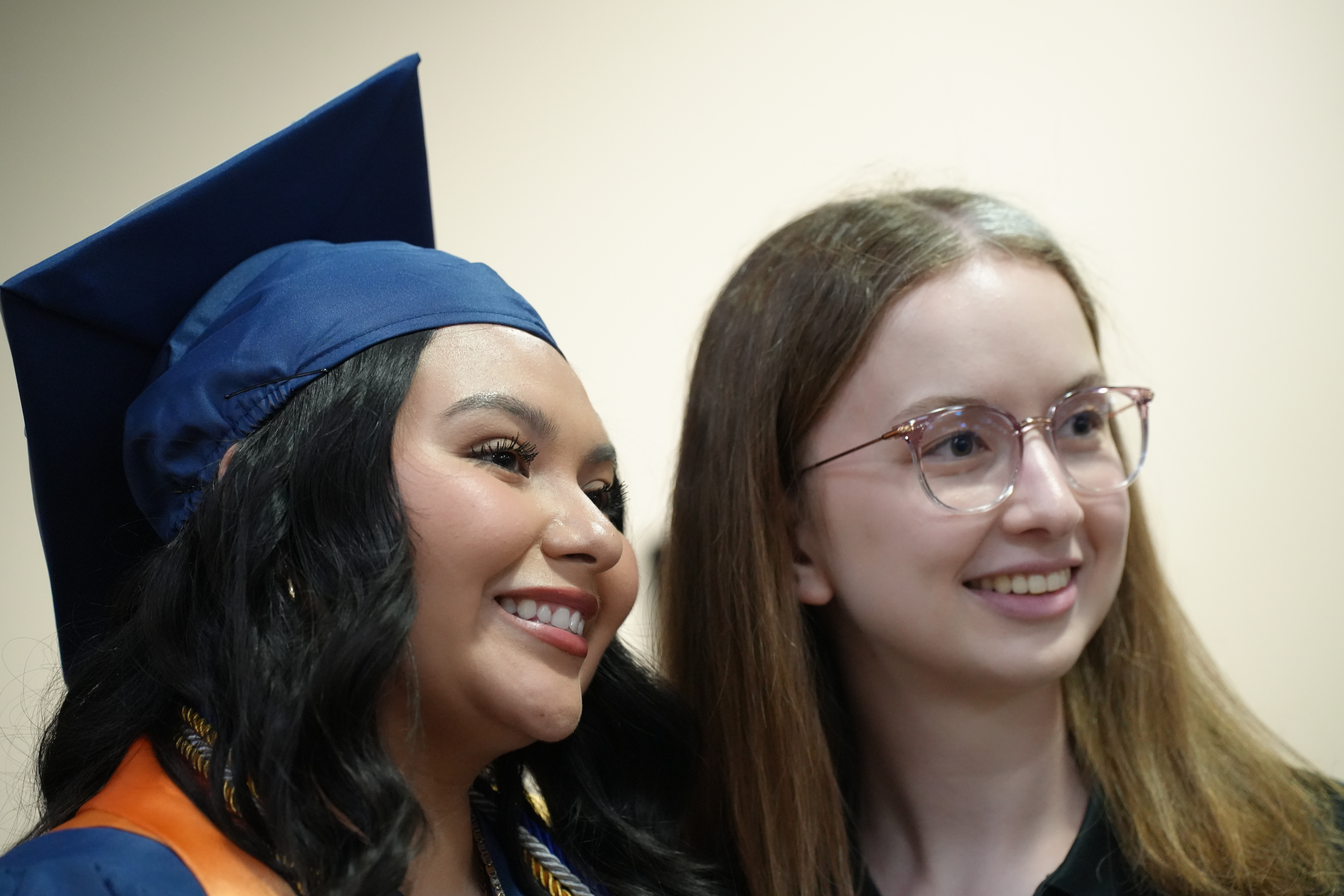 Elexiana Olivia posting next to a friend after graduation.